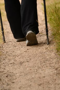 Background with a woman is nordic walking,Focus on foreground with space for text