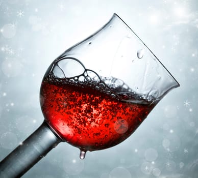 Glass of red wine against silver background