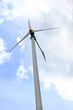 green meadow with Wind turbines generating electricity