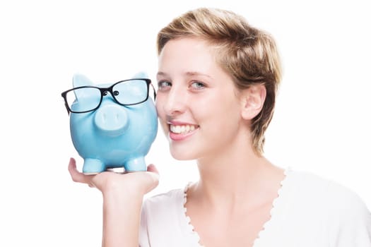 Young happy woman with blue piggy bank