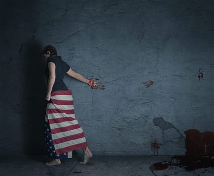 Young woman carries American flag and leaves a trail of blood