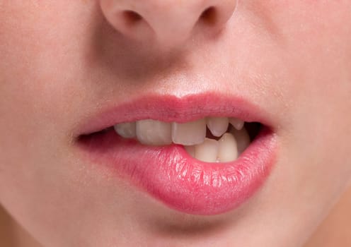 Close-up of a woman biting her lip