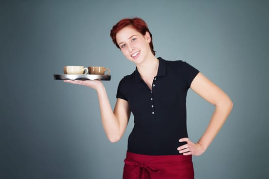Young red-haired waitress serving coffee