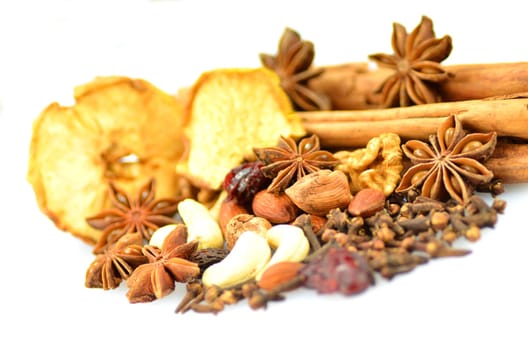 christmas spices, nuts and dried fruits isolated on white background