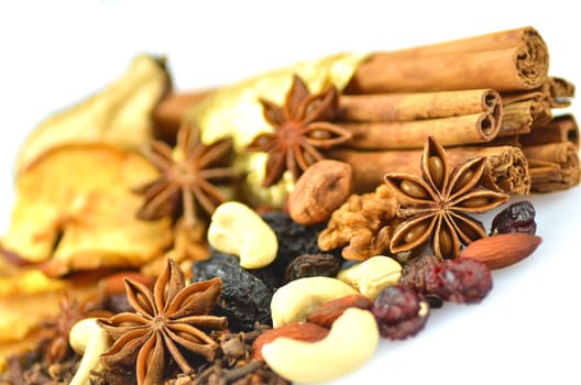 christmas spices, nuts and dried fruits isolated on white background