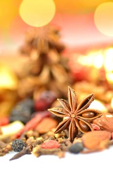 christmas spices, nuts and dried fruits on bokeh background
