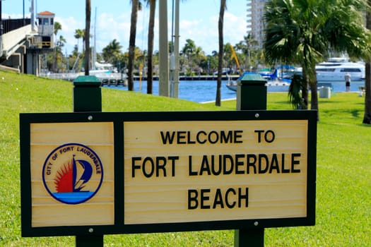 FORT LAUDERDALE, FLORIDA - FEBRUARY 3: Welcome to Fort Lauderdale Beach sign in Merle Fogg / Idlewyld park near Las Olas Intracoastal waterway drawbridge on February 3, 2013 in Ft Lauderdale, Florida