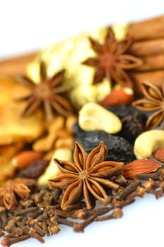 christmas spices, nuts and dried fruits isolated on white background