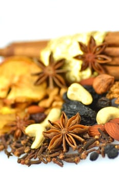 christmas spices, nuts and dried fruits isolated on white background