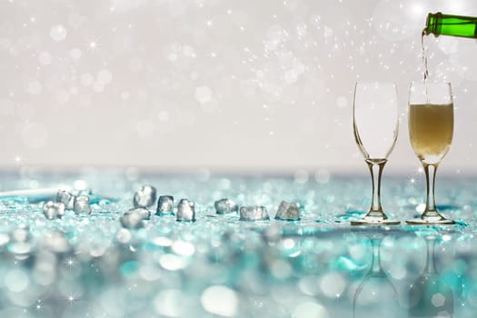 Pouring champagne against festive holiday lights