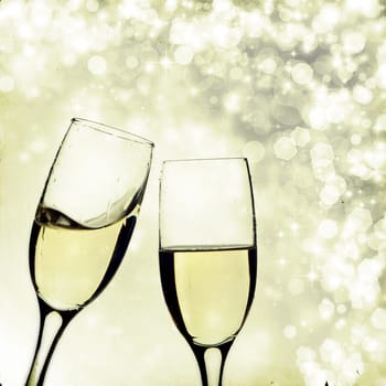 Vintage photo of glasses with champagne against holiday lights