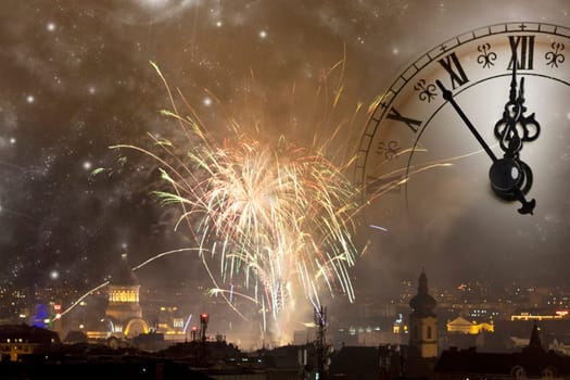 Holiday fireworks and clock close to midnight over the city