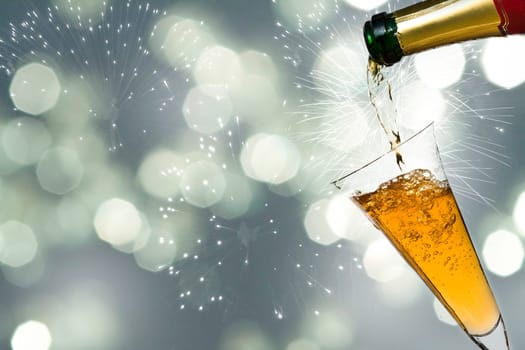 Glasses with champagne against holiday lights