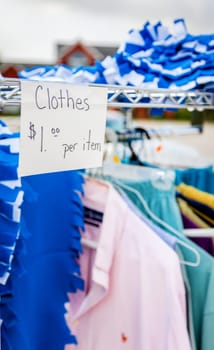 Closeup image of clothes and price tag at a garage sale