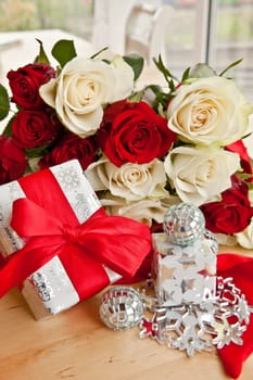 White and red roses with small gifts and decoration for Christmas