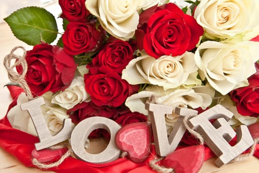 White and red roses and LOVE in wooden letters