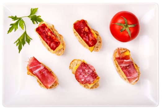 thin slices of Iberian sausage omelette with bread on white base