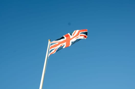 English flag in sunny autumn day against a blue sky