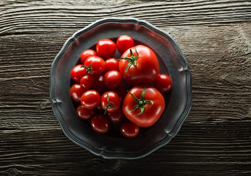 Fresh ripe tomatoes on wooden background close up