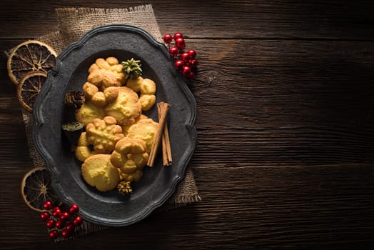 Fresh homemade cookies decorated on wooden background