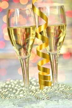 two glasses of champagne against bokeh background