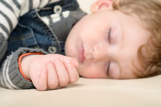Baby sleeping peacefully on the couch at home
