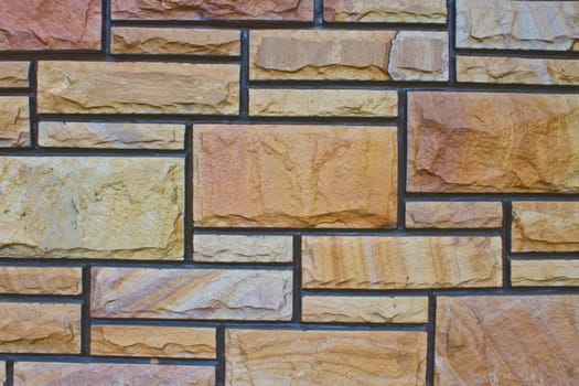 Textured stone wall in gaden at home, Thailand.