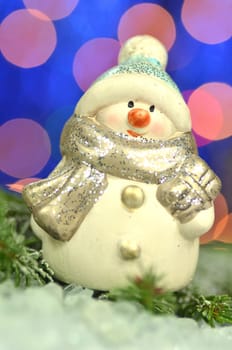 christmas decoration, figure of snowman against bokeh background