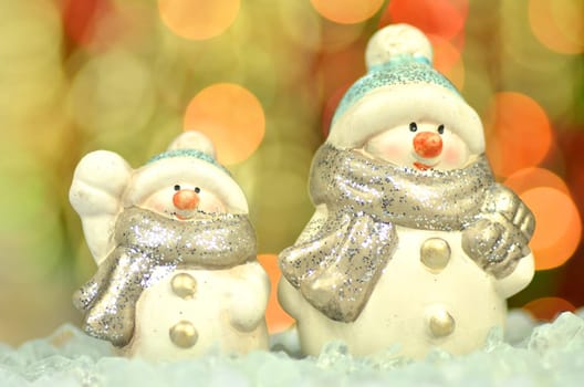 christmas decoration, two figures of snowman against bokeh background