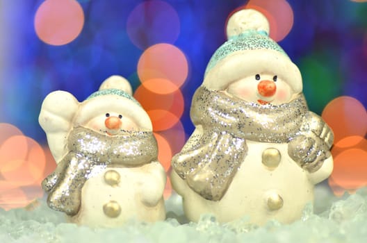 christmas decoration, two figures of snowman against bokeh background