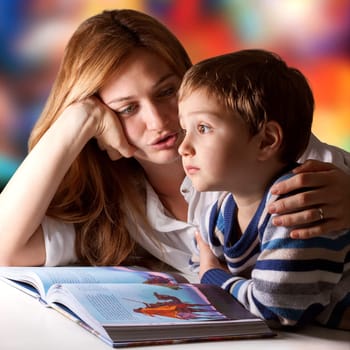 Little boy listening to his mother telling him stories