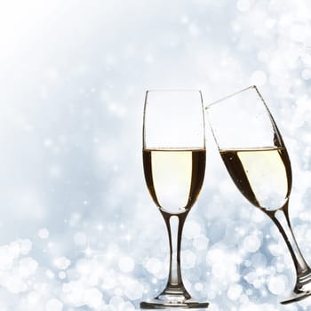 Glasses with champagne against fireworks