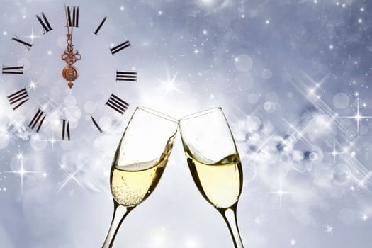 Glasses with champagne against holiday light and snowflakes