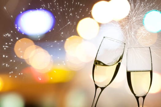 Glasses with champagne against fireworks and clock close to midnight