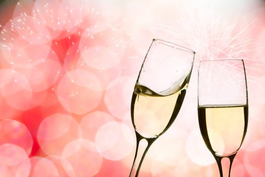 Glasses with champagne against fireworks and clock close to midnight