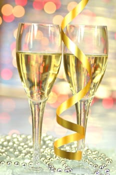 two glasses of champagne against bokeh background