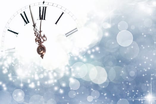 New Year's at midnight - Old golden clock with stars and snowflakes on the background
