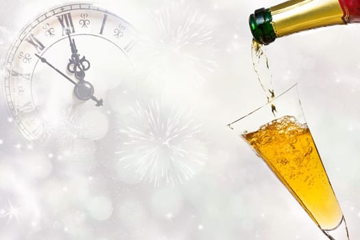 Glasses with champagne against fireworks and clock close to midnight