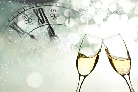 Glasses with champagne against fireworks and clock close to midnight