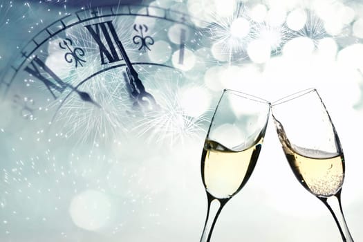Glasses with champagne against fireworks and clock close to midnight
