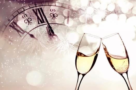 Glasses with champagne against fireworks and clock close to midnight