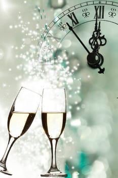 Glasses of champagne against clock close to midnight and fireworks