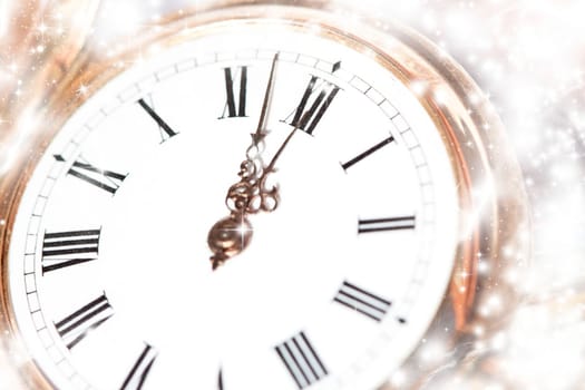 New Year's at midnight - Old golden clock with stars and snowflakes on the background
