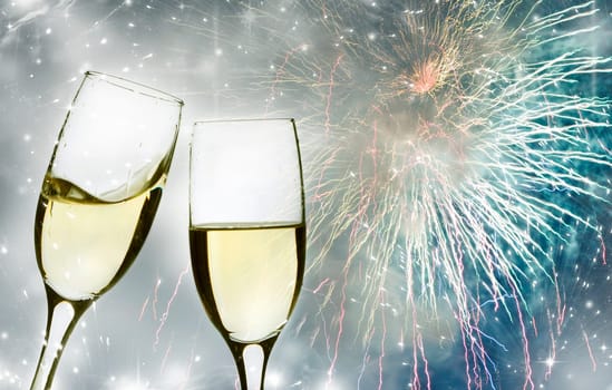 Glasses with champagne against fireworks and clock close to midnight
