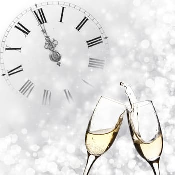 Glasses with champagne against holiday lights and clock close to midnight