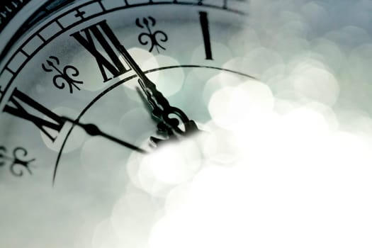 Close up on a vintage clock with sparkling background