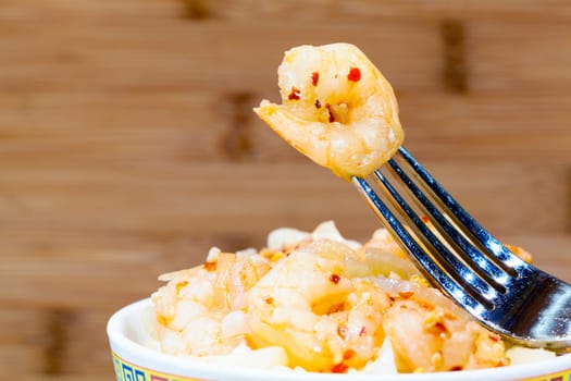 Closeup image of spicy shrimp on the fork