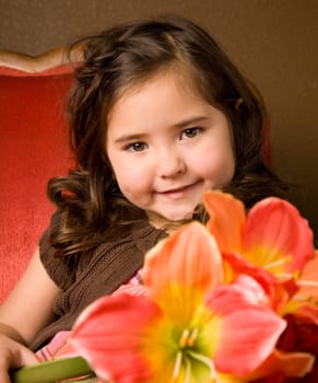 Portrait of a beautiful little girl with flowers