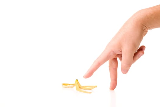 Conceptual image of finger-walking over a banana peel. Isolated on white background