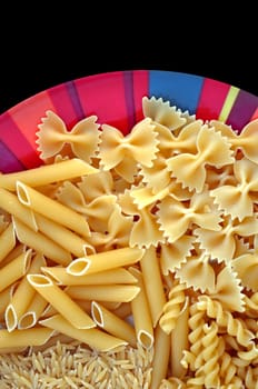 Colorful plate with italian pasta variety. Creative food background.